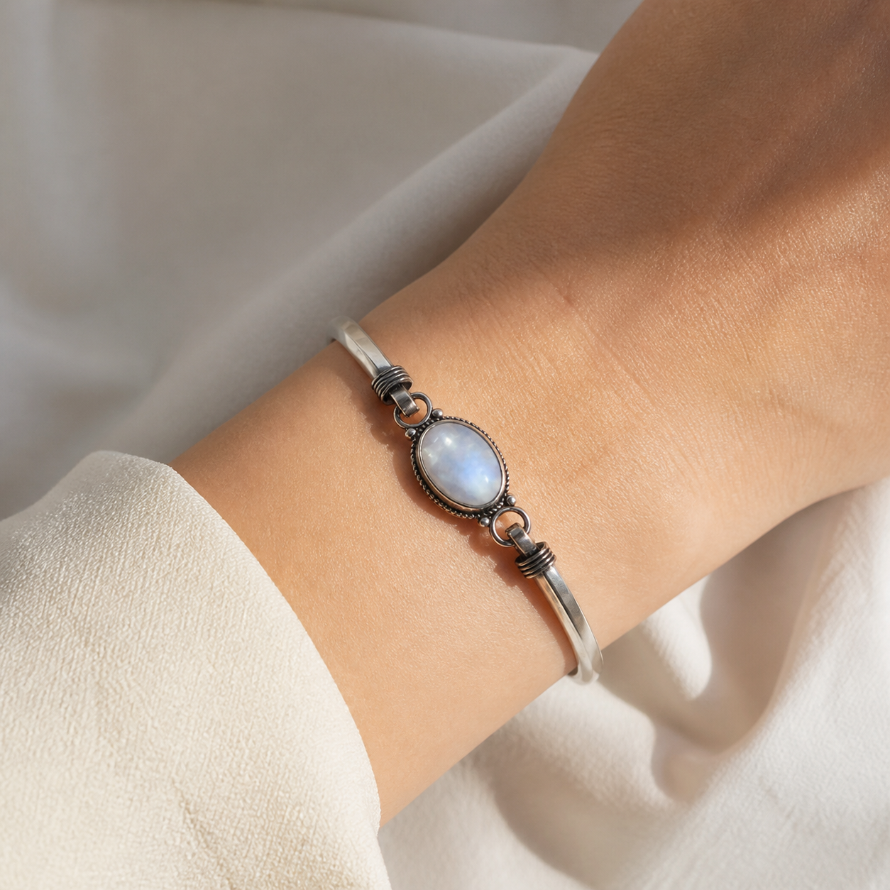 Bracelet en argent 925 et pierre de lune porté au poignet.