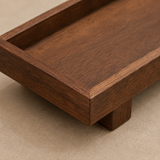 Détail de la texture et des finitions d’un plateau rituel en bois foncé